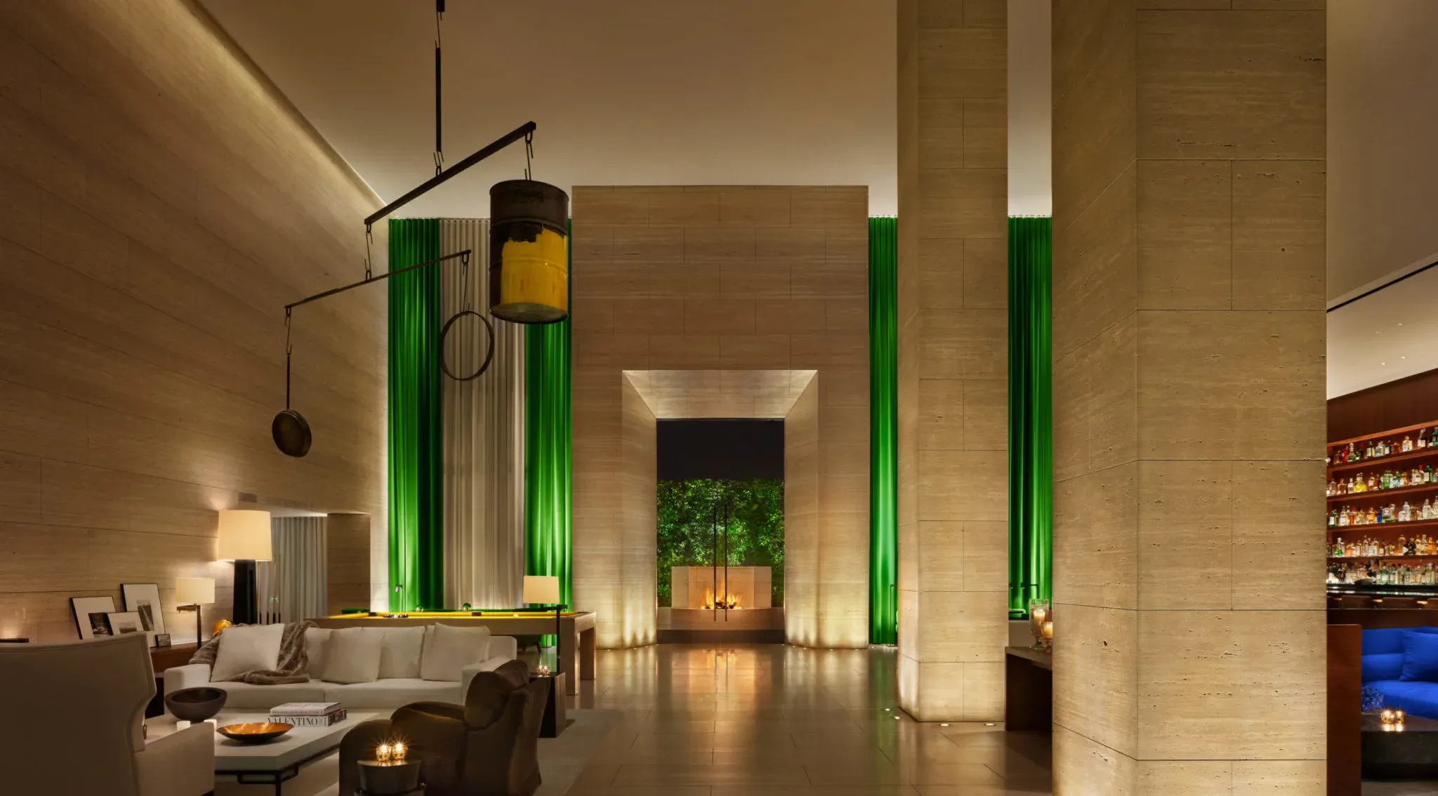 The lobby lounge, calm behind its green glass columns