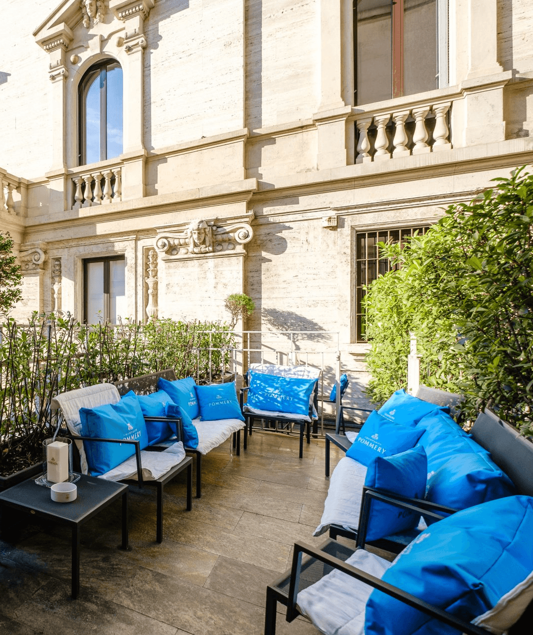 Outdoor terrace at Spazio Pio XI with blue seating