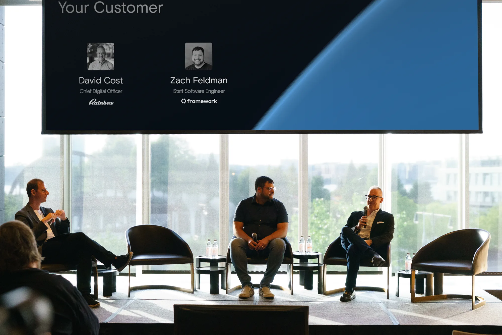 David Cost and Zach Feldman on stage with the moderator during the customer panel
