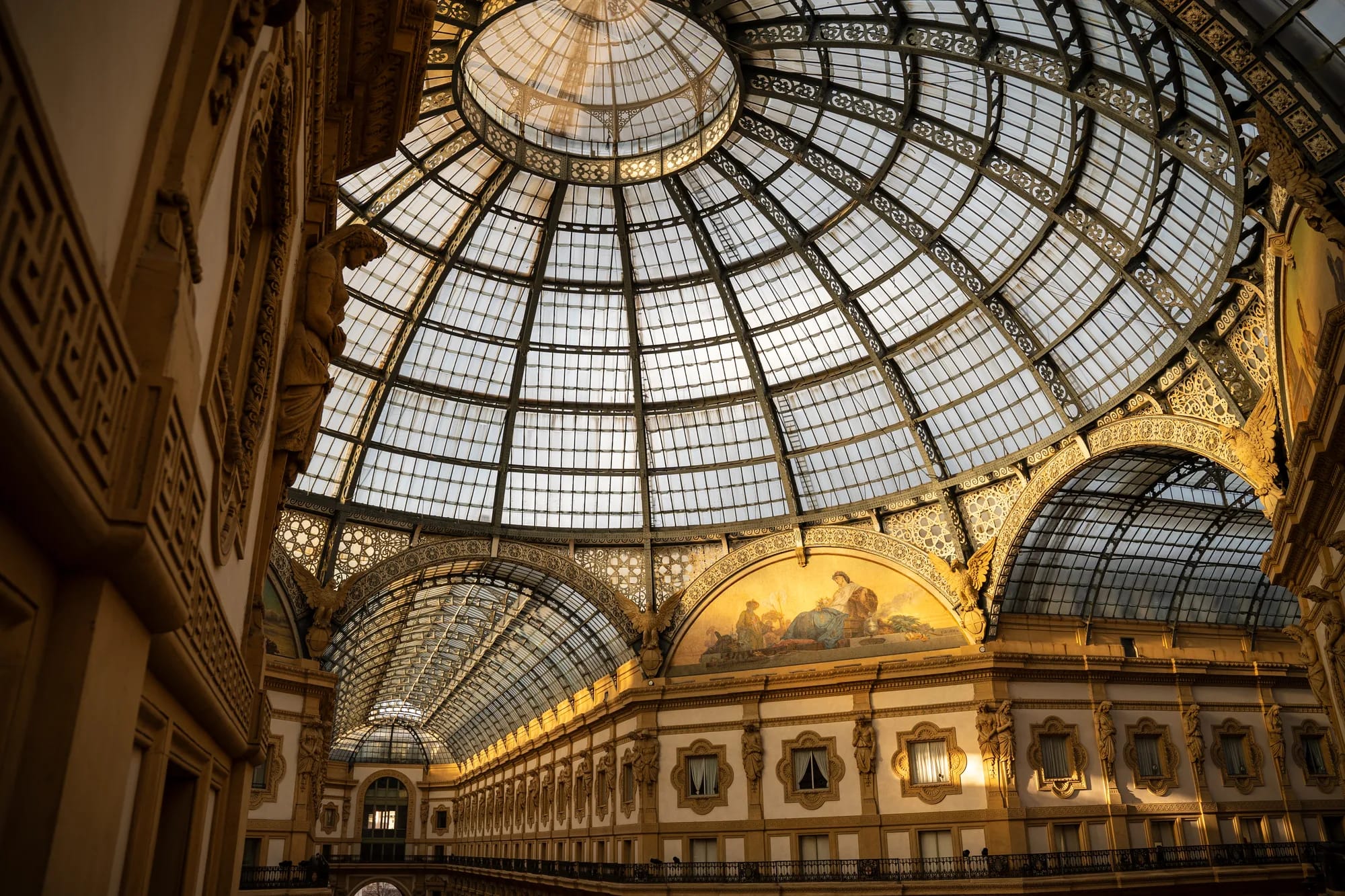 The glass and iron dome of Galleria Vittorio Emanuele II in warm light