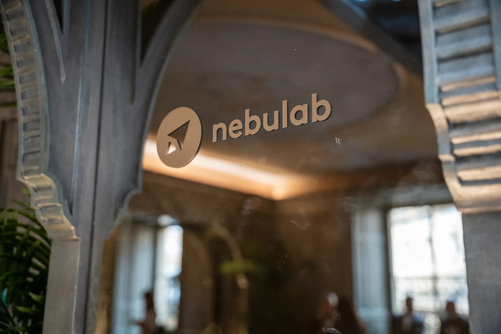 Nebulab logo on a glass panel framed by an ornate archway