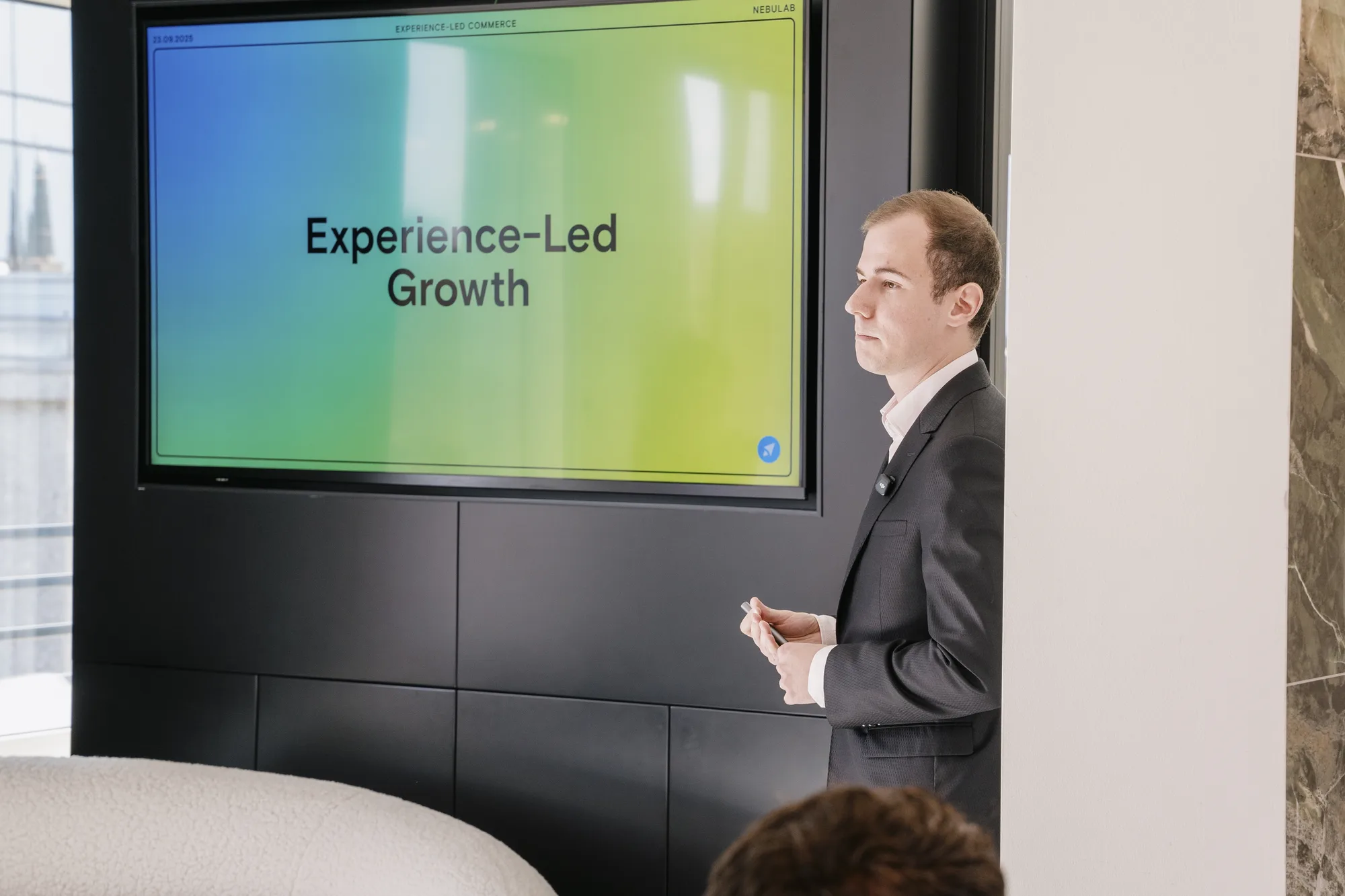Alessandro Desantis opens the event beside an "Experience-Led Growth" slide